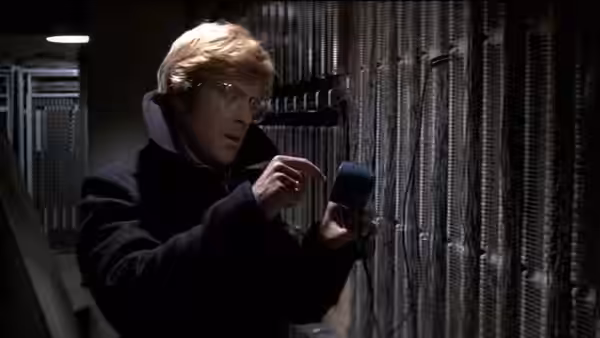 Joseph Turner (Robert Redford) inspecting equipment in a room filled with cables
