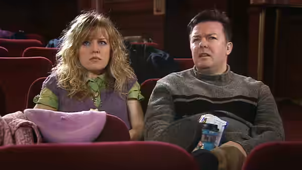 Maggie Jacobs and Andy Millman sit together in a cinema auditorium