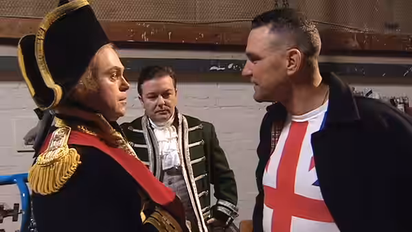 Man in ornate military uniform faces a man wearing an England shirt