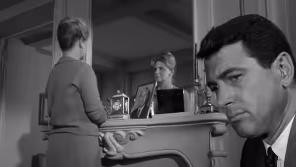 Arthur Hamilton (John Randolph) watches as his wife stands at the mantel