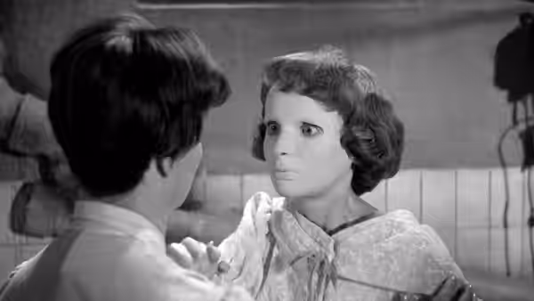 A dark-haired woman faces a young woman in a patterned dress