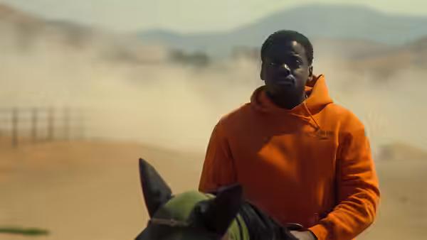 OJ Haywood (Daniel Kaluuya) rides a horse through a dusty ranch landscape