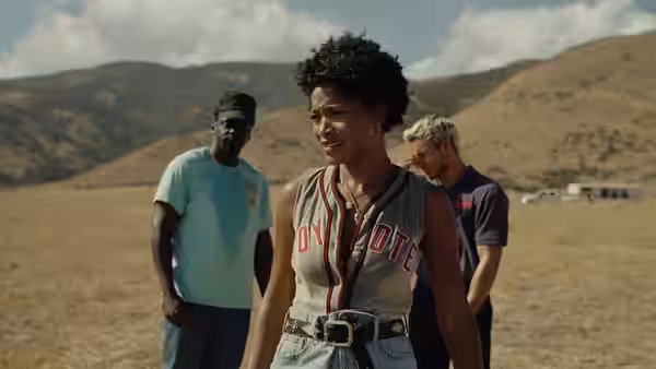 Emerald Haywood (Keke Palmer) walks across a dry ranch yard with two men behind her