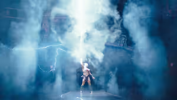 Muscular warrior raises glowing sword as lightning strikes through dense smoke