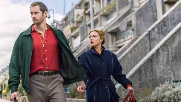 Alexander Skarsgård as Gadi and Florence Pugh as Charlie walk outdoors together