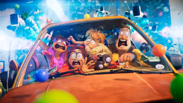 The Mitchell family and their pug huddle inside their car as robots and colorful objects fly around them
