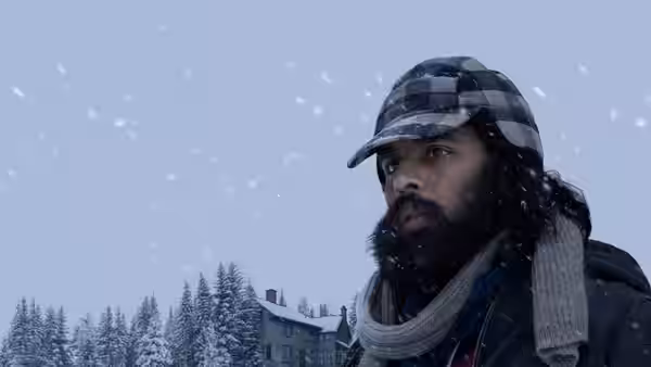 Jeevan Chaudhary (Himesh Patel) gazes upward amid falling snow in winter