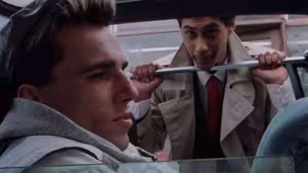 Johnny (Daniel Day-Lewis) in a car as Omar (Gordon Warnecke) stands outside