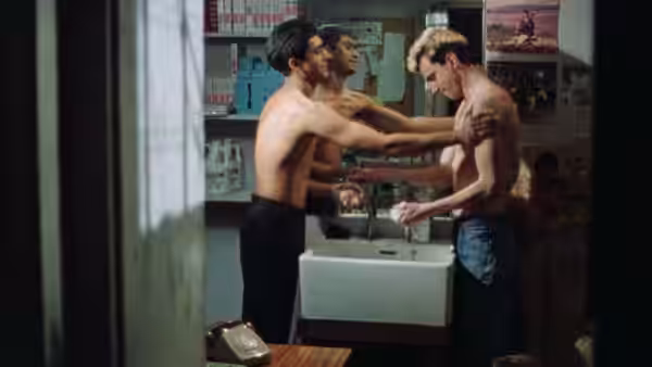 Johnny (Daniel Day-Lewis) held by two shirtless men at a bathroom sink