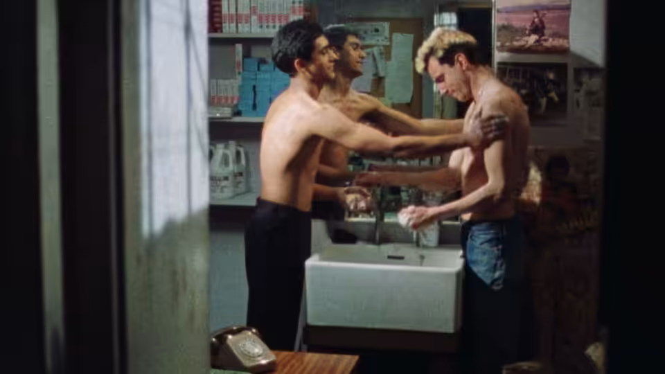 Johnny (Daniel Day-Lewis) held by two shirtless men at a bathroom sink