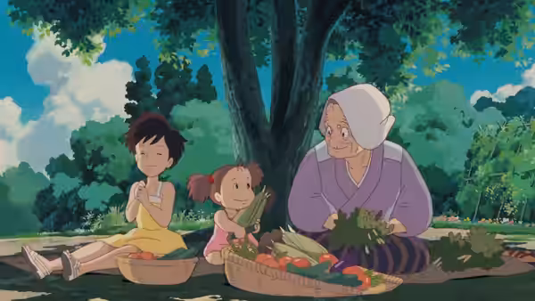 Granny with Satsuki and Mei sorting vegetables under a large tree