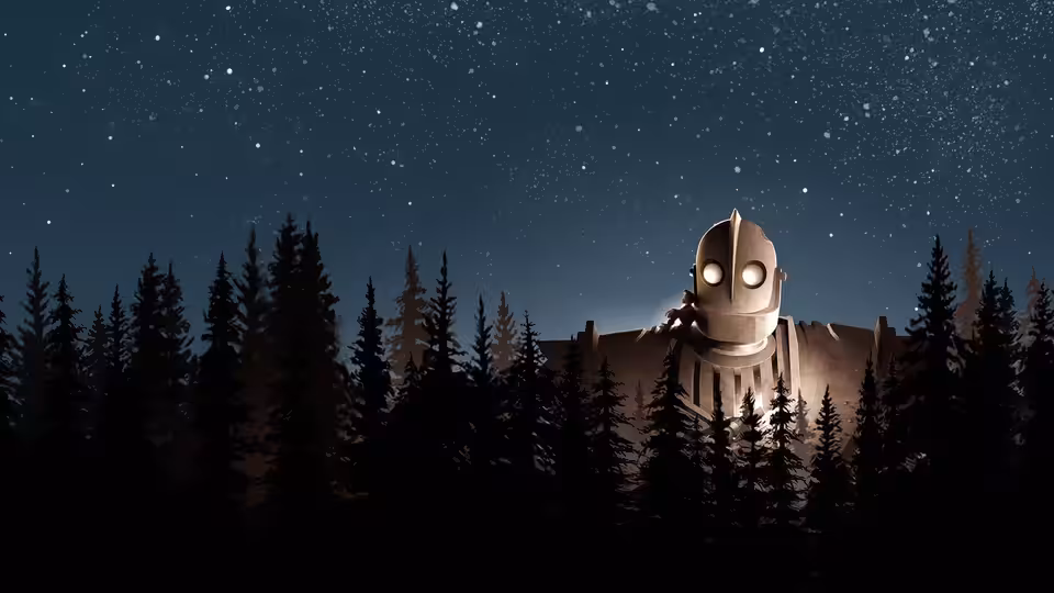 The Iron Giant standing behind trees under a starry night sky