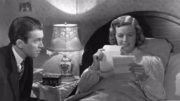 Alfred Kralik (James Stewart) watches as Klara Novak (Margaret Sullavan) reads a letter in bed