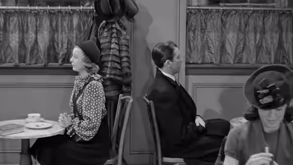 Klara Novak (Margaret Sullavan) and Alfred Kralik (James Stewart) sit back to back in a café