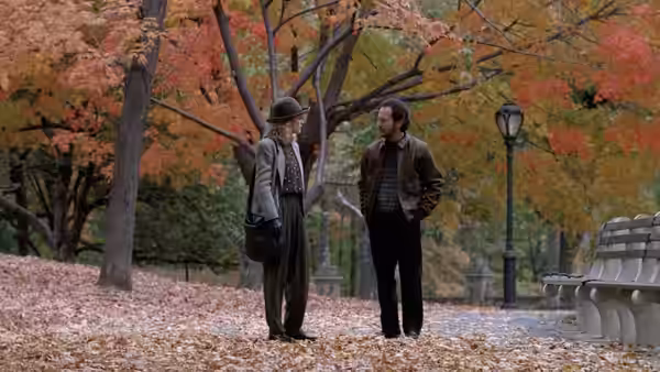 Sally (Meg Ryan) and Harry (Billy Crystal) stand facing each other in an autumn park