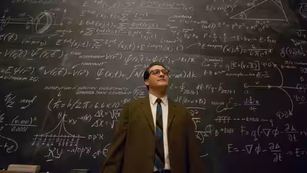 Larry Gopnik (Michael Stuhlbarg) standing before a chalkboard covered in equations