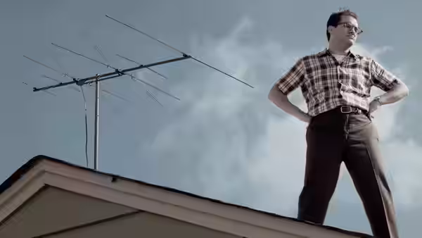 Larry Gopnik (Michael Stuhlbarg) standing on a rooftop beside an antenna