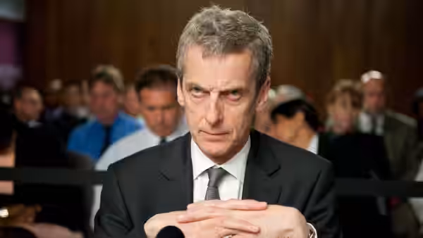 Malcolm Tucker (Peter Capaldi) with hands clasped at formal hearing