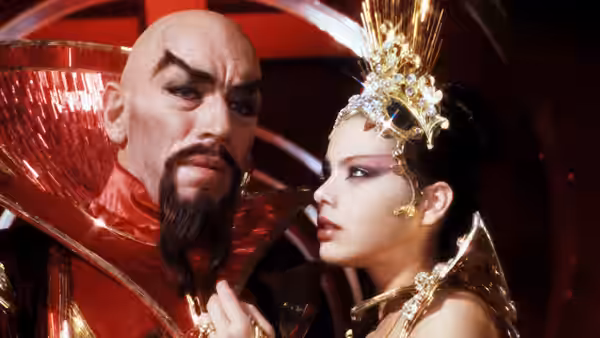 Emperor Ming (Max von Sydow) leans toward Princess Aura (Ornella Muti) in his palace