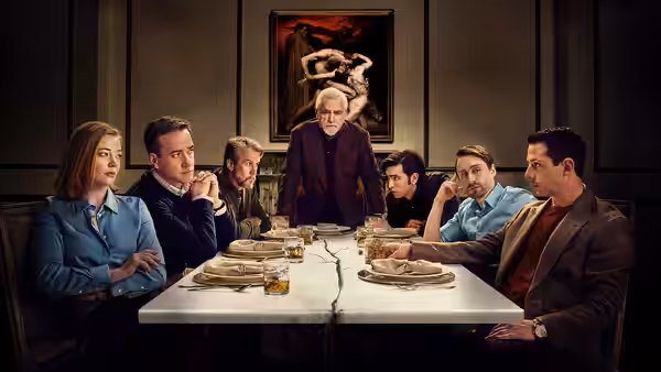 Logan Roy (Brian Cox) standing at the head of a family dinner table