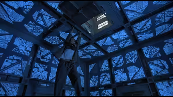 woman reaching up to ceiling hatch in blue metallic cube room