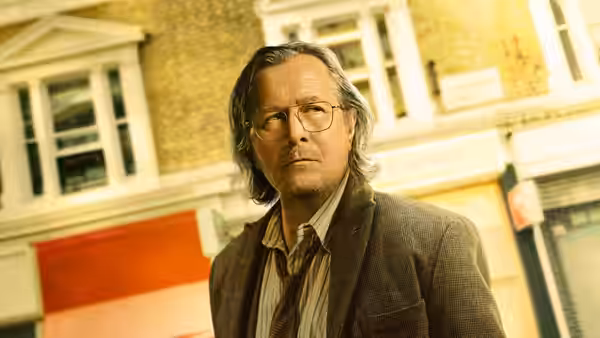 Jackson Lamb (Gary Oldman) standing on a quiet city street