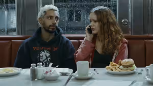 Ruben Stone (Riz Ahmed) and Lou (Olivia Cooke) sit together at a diner table