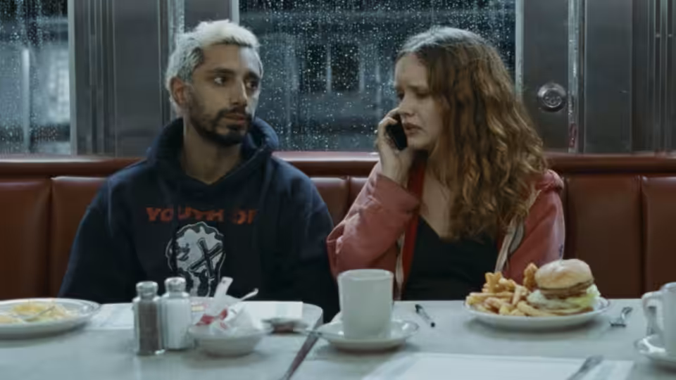 Ruben Stone (Riz Ahmed) and Lou (Olivia Cooke) sit together at a diner table