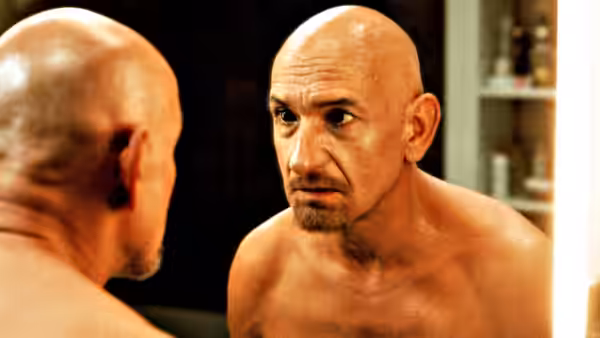 Don Logan (Ben Kingsley) staring at his reflection in a mirror