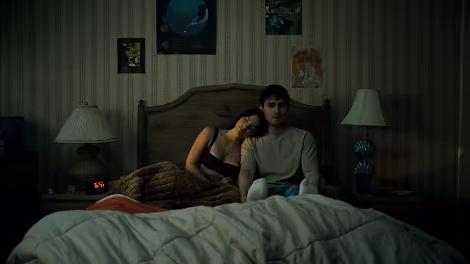 Bear (Michael Johnston) and Nikki (Inde Navarrette) sit together in bed