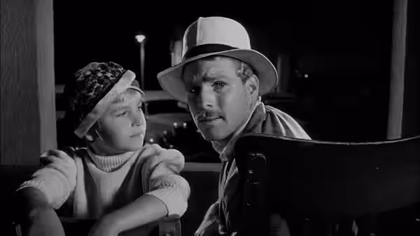 Addie Loggins (Tatum O'Neal) and Moses Pray (Ryan O'Neal) sit together on a porch at night