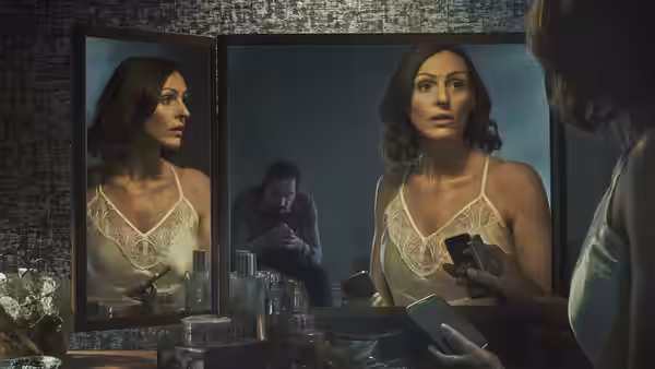 Dr Gemma Foster (Suranne Jones) examines her reflection as Simon Foster watches