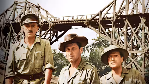 Three officers standing before the wooden bridge structure