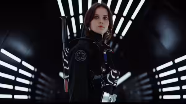 Jyn Erso (Felicity Jones) standing in a brightly lit Imperial corridor