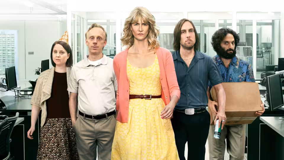 Amy Jellicoe (Laura Dern) standing with four colleagues in an office