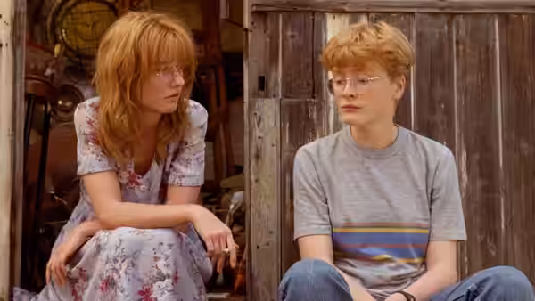 Nicola (Jane Horrocks) and Natalie (Claire Skinner) sit on the ground outside a shed