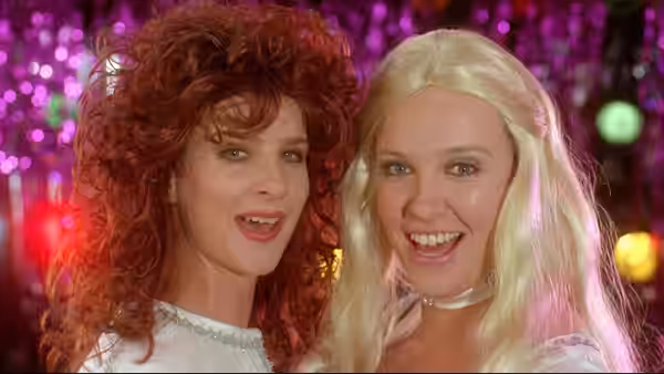 Rhonda (Rachel Griffiths) and Muriel (Toni Collette) smiling together at a nightclub
