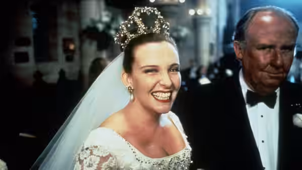 Muriel (Toni Collette) smiling in tiara beside Bill Heslop (Bill Hunter)
