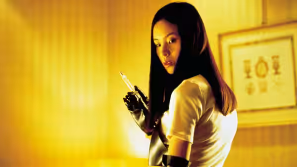 Asami Yamazaki (Eihi Shiina) holds a syringe in a warmly lit room