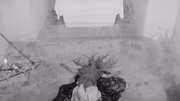 A person lies sprawled on the ground beneath a raised doorway