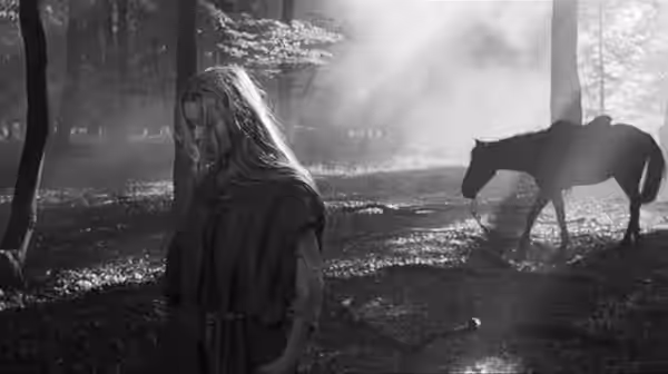 Marketa Lazarová (Magdaléna Vášáryová) stands beside a horse in a wooded clearing