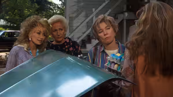 Truvy Jones (Dolly Parton), M'Lynn Eatenton (Sally Field) and Ouiser Boudreaux (Shirley MacLaine) peer into a metal tub