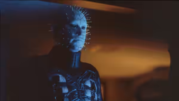 Pinhead (Doug Bradley) standing in a dimly lit interior
