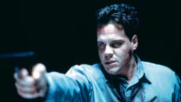 Det. Joseph Thorne (Craig Sheffer) aiming a gun forward intently