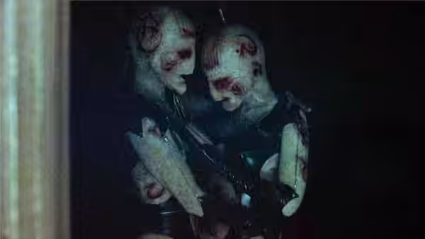 Two pale injured figures embracing closely in darkness