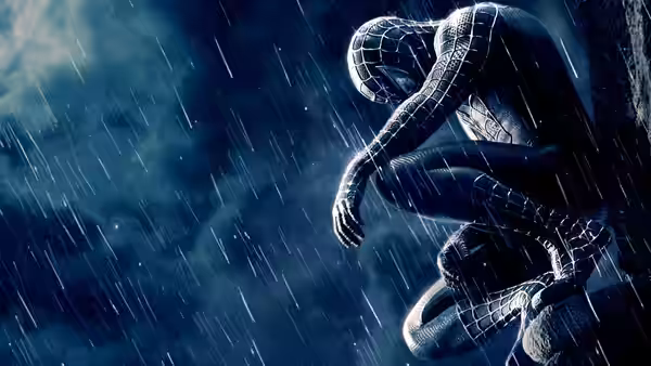 Spider-Man crouches on a building ledge in the rain, wearing his black suit