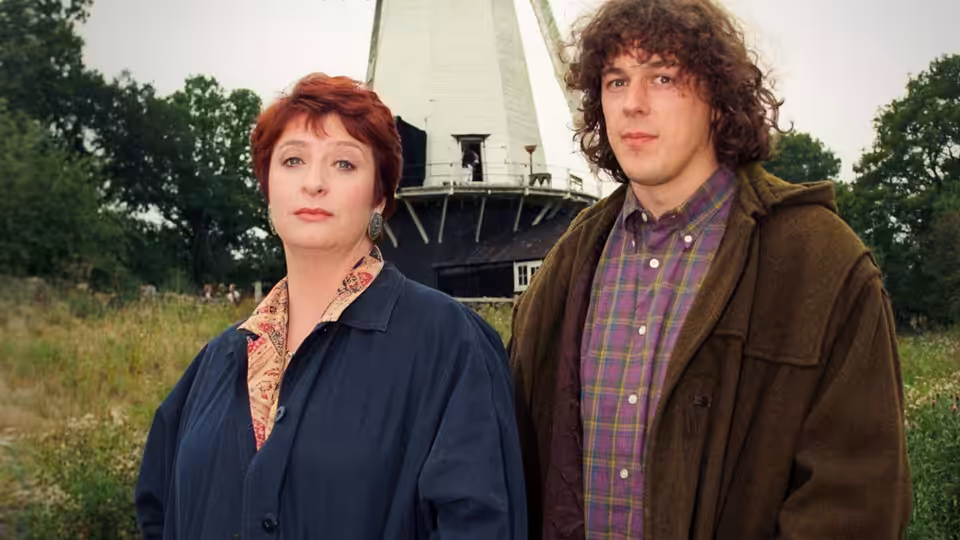 Maddy Magellan (Caroline Quentin) and Jonathan Creek (Alan Davies) standing before a windmill