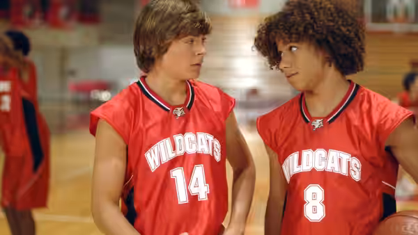 Troy (Zac Efron) and Chad (Corbin Bleu) in Wildcats jerseys facing each other