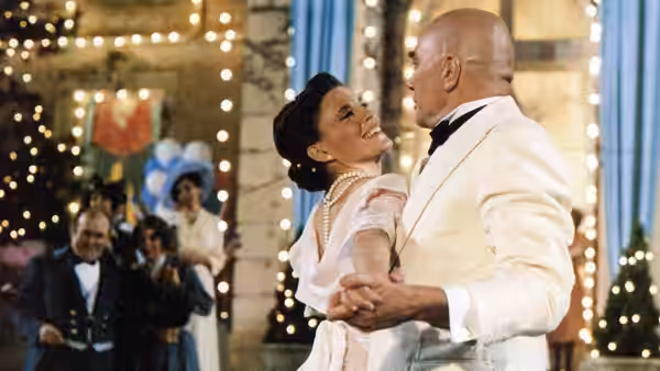 Daddy Warbucks (Albert Finney) dances closely with Grace Farrell (Ann Reinking) in a ballroom