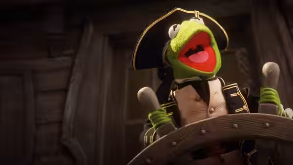Kermit the Frog gripping the ship's wheel with mouth wide open